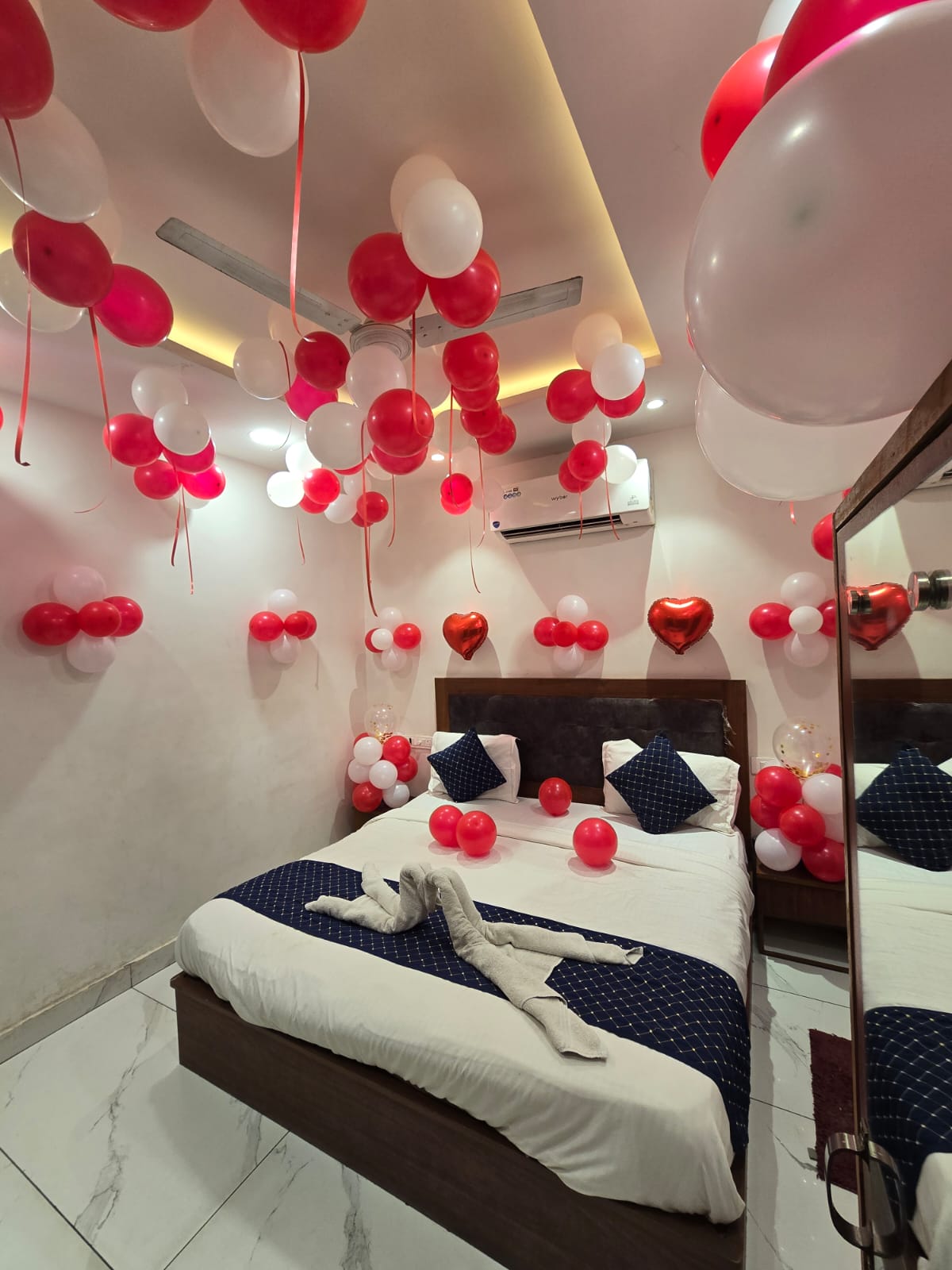 Clean decorated room with balloons and king bed